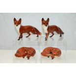 Four Beswick Foxes - two standing,