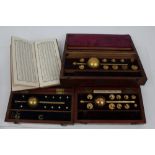 Three sets of Sikes hydrometers in mahogany cases and a hydrometer table book