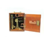 Late 19th century brass microscope with accessories, in a fitted mahogany case,