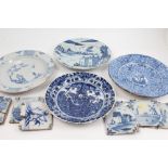 Four 18th century Delft blue and white tin glazed chargers with painted decoration,
