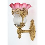 Good quality early 20th century ormolu wall sconce with pink tinted glass shade and ornate cherub