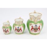 Set of three early 19th century English porcelain graduated armorial jugs,