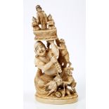 Late 19th century Japanese carved ivory figure of a monk holding three figures above his head,