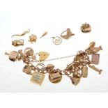 Gold charm bracelet with a collection of gold and yellow metal charms,