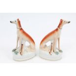 Pair Victorian Staffordshire pottery greyhounds with dead hares,