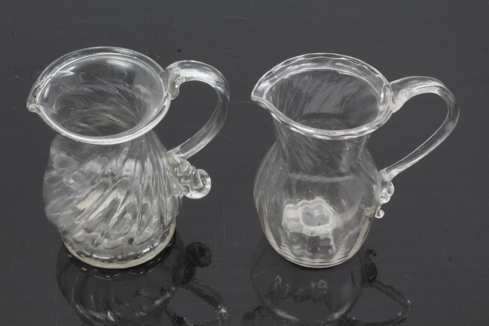 Two Georgian glass cream jugs with spiral-twist decoration, fold-over rims and loop handles, 8.