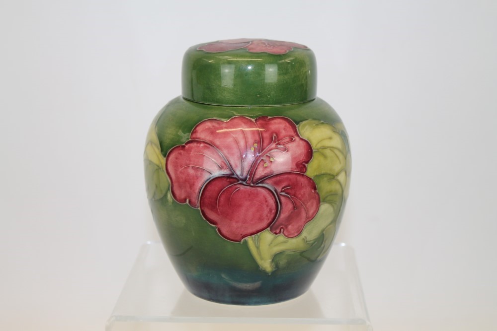 Moorcroft pottery Hibiscus pattern ginger jar with red flowers on green ground,