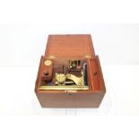 Late Victorian brass microscope with accessories,