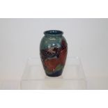 Moorcroft pottery Bullfinch pattern miniature oviform vase with tube-line bird and fruit decoration