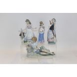 Four Lladro porcelain figures - including girl holding flower and her hat, girl with hare,
