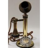 Early 20th century brass candle telephone with braided line and separate earpiece