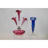 Victorian cranberry glass three-branch epergne, together with a Victorian blue glass spill vase,