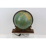 Early 20th century Cram's Unrivalled 12 inch illuminated terrestrial globe on a gilt metal Atlas