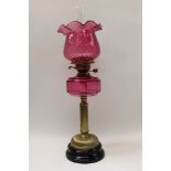 Victorian oil lamp with duplex burner, cranberry shade with flared border and clear glass chimney,