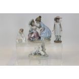 Four Nao porcelain figures - including two girls with doll