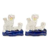 Pair Victorian Staffordshire poodle with puppies inkwells with baskets of flowers in mouths,