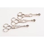 Three pairs of good mid-18th century silver sugar nips with scissor-action, cast shell bowls,