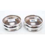 Pair contemporary silver bottle coasters of bellied form,