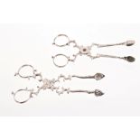 Two pairs of mid-18th century Irish silver sugar nips with scissor-action and chased decoration,