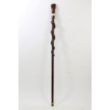 African tribal hardwood stick carved with fist terminal, the tapering staff with entwined snake,