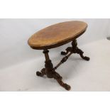 Victorian walnut oval stretcher table, the quarter-veneered top with moulded edge,