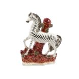 Victorian Staffordshire zebra spill vase with moulded features, on naturalistic base, circa 1860,