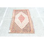 Good quality Eastern tribal rug centred by diamond medallion and concentric motifs within geometric