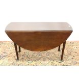 18th century mahogany drop-leaf dining table, the oval hinged top on turned legs and pad feet,