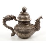 Interesting Tibetan silver teapot of small proportions, with chased and engraved foliate decoration,