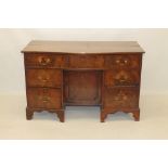 George III grained mahogany serpentine knee-hole desk,