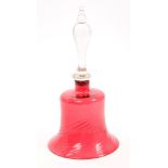 Victorian cranberry tinted glass bell with spiral-twist decoration and clear glass handle,
