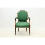 George III mahogany framed open armchair, the oval padded back with padded scroll arms,