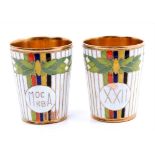 Pair Russian gilt metal and brightly coloured enamel vodka cups commemorating Moscow Olympics,