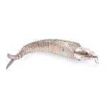 White metal articulated fish with hinged head, red glass eyes and suspension ring,