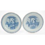 Pair mid-18th century English Delft blue and white dishes painted with Oriental figure in domestic