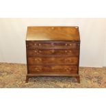 George III mahogany bureau with fitted interior about central cupboard door and four graduated