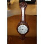 Late Victorian aneroid barometer / thermometer in carved oak case and one other circular barometer