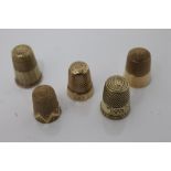 Five antique yellow metal thimbles, 2.5cm and smaller - one stamped - 10k, one stamped - 14k.