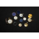 Four pocket compasses in leather cases,