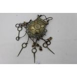 Nigerian tribal brass purse with geometric ornament, hung with cowrie shells,