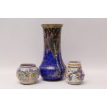 Carlton Ware vase with gilt and painted floral decoration on blue ground and two Poole Pottery