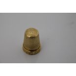 Antique gold (18ct) thimble with foliate border, stamped - 18, 2.3cm high.