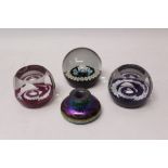 Iridescent glass inkwell and three Caithness paperweights
