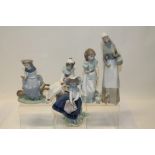 Five Lladro porcelain figures - lady with dog, boy with instrument, girl with vase of flowers,