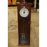 Early 20th century Master clock with circular dial and weighted pendulum in mahogany case with