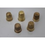 Five antique yellow metal thimbles, the largest 2.4cm high - one stamped - 10k.