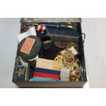 Tin containing medals, postcards, miniature playing cards, lighters,