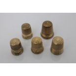 Five antique yellow metal thimbles, the largest 2.2cm high, four stamped - 14k, one stamped - 10k.