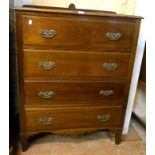 A 35 1/2" 20th Century stained oak chest of four long drawers, with decorative apron, set on