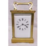 A brass and bevelled glass cased carriage clock with eight day movement